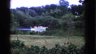 Wauconda Illinois USA (1960): Full Boat Slowly Moves Down River