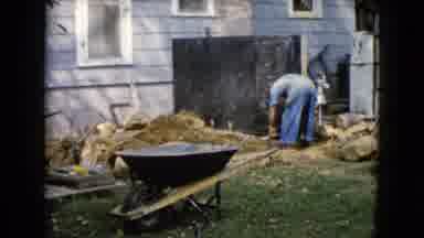 Wauconda Illinois USA (1960): Man Working In Backyard Landscaping With Wheelbarrow