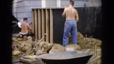 Wauconda Illinois USA (1960): Shirtless Men Drinking A Beverage And Hammering On A