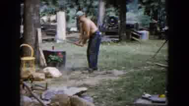 Wauconda Illinois USA (1960): Two Bare Chested Men Work With Hammer Outside To