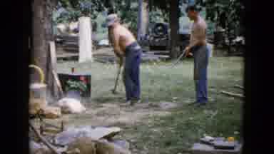 Wauconda Illinois USA (1960): A Man Is Breaking Stone With Hammer And Woman Giving