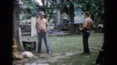 Wauconda Illinois USA (1960): Two Men Shirtless Playing In The Yard With Rifle And