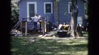 Wauconda Illinois USA (1960): Men Building Wooden Construction Behind House Using