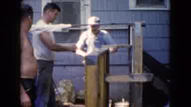Wauconda Illinois USA (1960): Man Outback Talking While Working To Fix A Fence