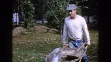 Wauconda Illinois USA (1960): Man Pushing A Wheelbarrow Full Of Cement To The