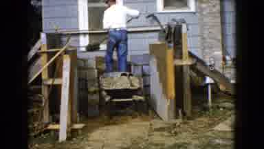 Wauconda Illinois USA (1960): Man Works On Building A Porch With Shovel And