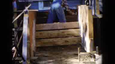 Wauconda Illinois USA (1960): Man In Jean Overalls Works On A Wooden Structure