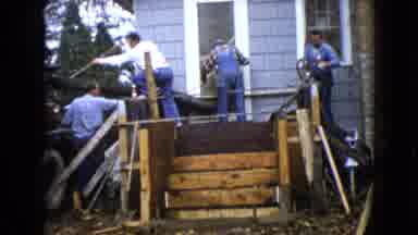 Wauconda Illinois USA (1960): Construction Workers Spread Wet Cement Onto Porch