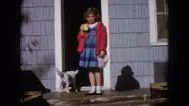 Wauconda Illinois USA (1960): Girl Wearing Blue Dress Drinks From White Cup While