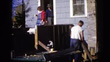 Wauconda Illinois USA (1960): Man Using A Hammer To Build Deck Near Home