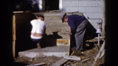 Wauconda Illinois USA (1960): Girl Wearing Blue Dress Watches Men Work On Wooden