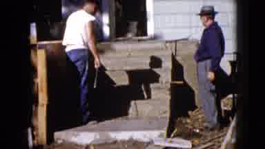 Wauconda Illinois USA (1960): A View Of Men Working Outside Fixing On A House