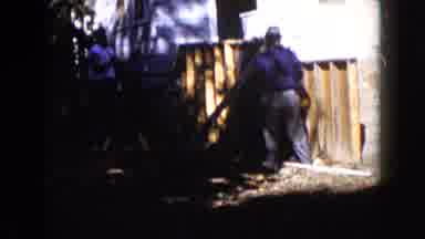 Wauconda Illinois USA (1960): The Three Persons Are Doing Something In The Wall