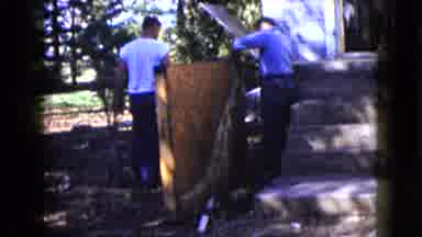 Wauconda Illinois USA (1960): Men Renovating A House In Forested Area On A Sunny