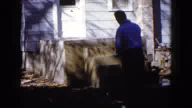 Wauconda Illinois USA (1960): Man Spraying Water On Newly Constructed Porch And