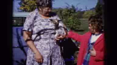 Wauconda Illinois USA (1960): Older Woman Holding A Puppy And Young Girl Standing