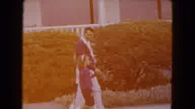 Buffalo New York USA (1961): Man Wearing Red Sweater Walks With Girls Wearing Red