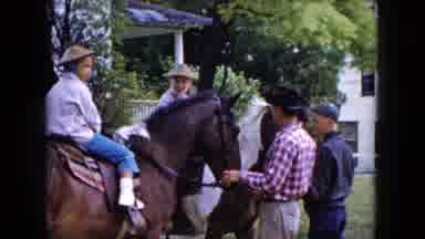 Buffalo New York USA (1961): Two Children In Hats Riding Horses In A Yard While