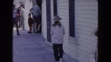 Buffalo New York USA (1961): Two Children In Hats Excited And People In Background