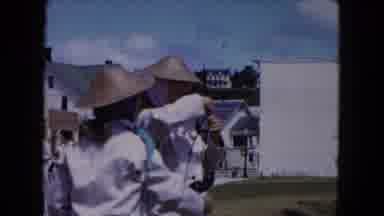 Buffalo New York USA (1961): Two People Wearing Hats One Hands The Other A Pair Of
