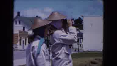 Buffalo New York USA (1961): Two People In Hats Stand Next To Each Other One Looks