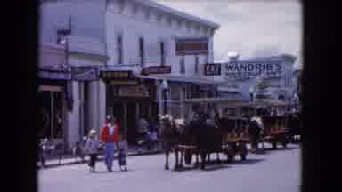 Buffalo New York USA (1961): Person Wearing Red Sweater Walks Past Stagecoach With