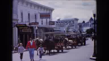Buffalo New York USA (1961): Person Wearing Red Sweater Walks Past Stagecoach With