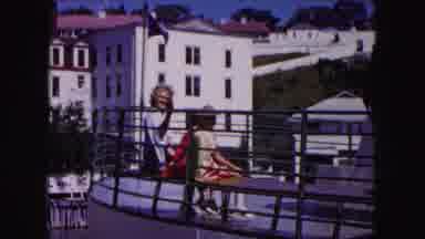 Buffalo New York USA (1961): A Video Split Between People Sitting By A Rail And A