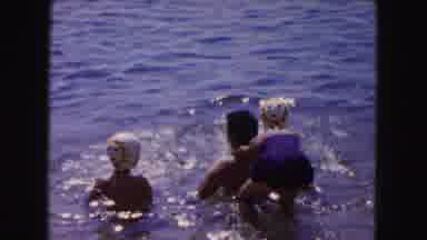 Buffalo New York USA (1961): Two Young Girls Playing In The Water With A Family