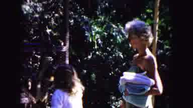 Buffalo New York USA (1961): Woman Wearing Green Swimwear Walks In Shallow Water