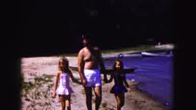 Buffalo New York USA (1961): Man With Two Female Children Walk On Beach While A