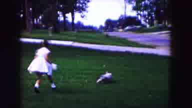 Buffalo New York USA (1961): Young Girls In Dresses Chasing Small Dog In Front