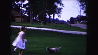 Buffalo New York USA (1961): Two Well Dressed Little Girls Chasing Dog Around On