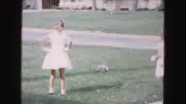 Buffalo New York USA (1961): Two Sisters Dressed For Easter Chasing A Dog Outside