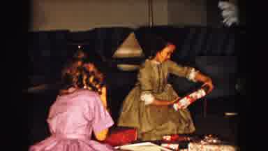Buffalo New York USA (1961): Two Young Girls In Dresses Opening Presents On