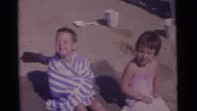 Camden New Jersey USA (1961): Two Children Smile For Camera At Beach A Boy Wrapped
