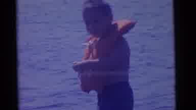 Camden New Jersey USA (1961): Child On A Boat With A Life Preserver On His Neck