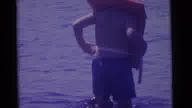 Camden New Jersey USA (1961): Boy Wearing Orange Life Vest Wades In Water While