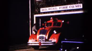 Hagerstown Maryland USA (1961): Red Vintage Fire Truck Exits Garage On A Bright