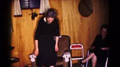 Hagerstown Maryland USA (1961): A Woman Adjusts Dress Before Sitting Down In Chair