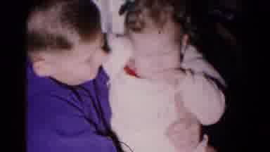 Hagerstown Maryland USA (1961): Boy Picking Up A Teething Baby Wearing Warm Winter