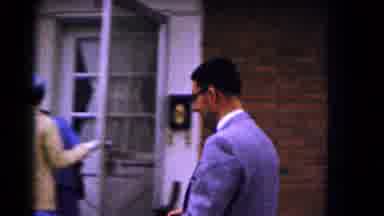 Hagerstown Maryland USA (1961): A Man Walks In Front Of The House Another Man Is