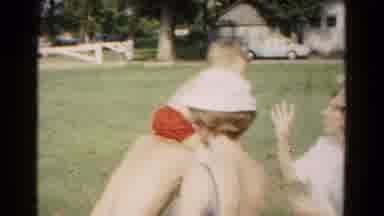 Hagerstown Maryland USA (1961): A Child Rides Piggyback On An Older Man Who Bends