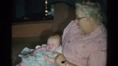Catskill New York US (1962): Smiling Grandmother Cuddles Newborn Inside As Other