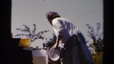Catskill New York US (1962): A Lady Picking Up Kitchen Utensils And Taking Them To