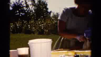 Catskill New York US (1962): Woman Wearing White Dress Washes Plastic Bottles On A