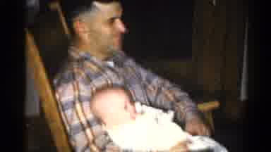 Catskill New York US (1962): Man In Plaid Shirt With A Baby In A Rocking Chair