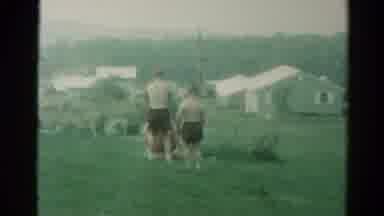 Catskill New York US (1962): Boys Playing In A Grassy Field With Houses In The