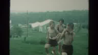 Catskill New York US (1962): Young Children Cheerfully Playing With A Sprinkler In