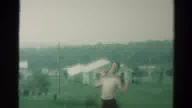 Catskill New York US (1962): Girl Splashing Boys With Lawn Sprinkler As They Run
